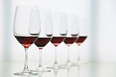 Wine glasses with red wine in a row, blurred