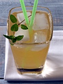 Close-up of greenwich drink with straws in glass