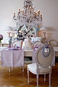 Festively decorated table in creme with chandelier on top