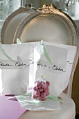 Sweets packed in paper bags decorated with feathers