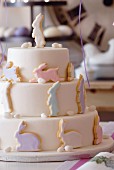 A three-tier Easter cake decorated with pastel-coloured rabbits