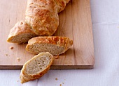 Sliced malfatto bread on wooden board