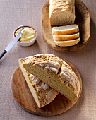 Slices of white wheat and corn bread on wooden board