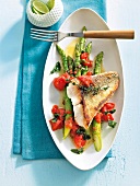 Zander fillet with green asparagus in serving dish