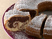 Close-up of marble cake with icing sugar on plate