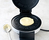 Blob of dough on machine for preparation of waffles
