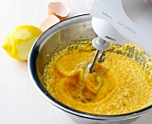 Close-up of batter being stirred in bowl for preparation of waffles
