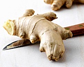 Close-up of ginger root on knife