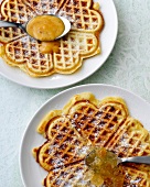 Orange waffles and buttermilk waffles on plates