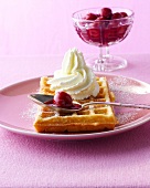 Bergische waffles with cherries and cream on plate