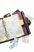 Sticky notes, notebook, socks and pregnancy calendar diary on white background