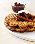 Whole grain waffles with roasted plums and cinnamon on tray