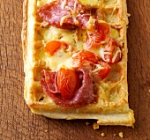 Close-up of waffles with salami and cherry tomatoes