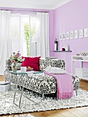 Black and white patterned sofa and white patio door in bedroom