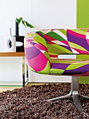 Close-up of colourful swivel chair on brown carpet