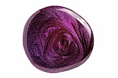Blob of dark purple nail polish on white background
