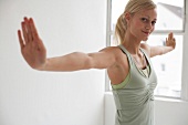 Blonde woman in sportswear performing cardio pilates to strengthen the body and burn fats