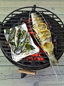 Lemon trout with capers, and sardines with herbs and garlic on grill
