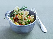 Colourful pasta salad with peas, sweetcorn, chives and diced salami