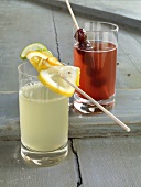 Two glasses of lemonade with fruit skewers