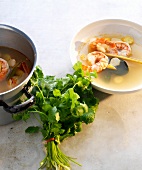 Shrimp soup and baby corn in bowl with coriander