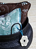 Close-up of blue and brown cushions with floral motifs in bag
