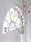 Branches decorated with colourful hanging paper flowers