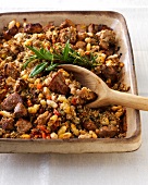 Close-up of Mediterranean bean in casserole with wooden spoon in serving dish
