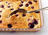 Close-up of clafoutis with cherries in glass baking dish