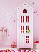 Child's bedroom in pink with mushroom lamp and house-shaped wardrobe