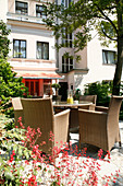 View of sitting area with wicker furniture outside hotel, Germany