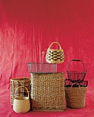 Different types of wicker baskets against red background