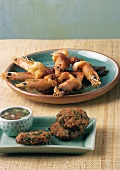 Crunchy shrimp and fish cakes with dipping sauce on plate