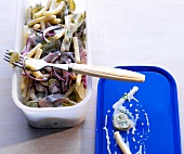 Herring salad in plastic container