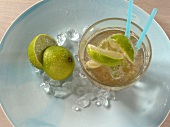 Ipanema drink with halved lemon and crushed ice on plate