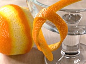 Close-up of orange, orange peel and glass