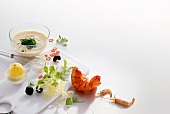 Shrimp, lobster tail, lemon, lettuce, mayonnaise, truffle and chilli on white background