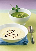 Cream of pea soup with mint pesto and cream of celery soup in bowl