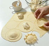 Quark filling on dough circles being covered with dough, step