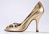 Gold peep toes on white background