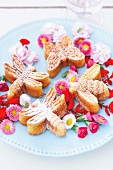 Close-up of butterfly, bee and dragonfly shaped biscuits served on plate