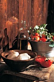 Mozzarella balls in bowl with tomato and oil