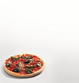 Pizza with artichokes, prosciutto and herbs on white background