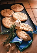 Five herbal breads with garlic and rosemary in baking tray