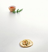 Pita bread with feta cheese, dill and paprika on white background