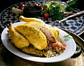 Close-up of stuffed chicken with rice and tomatoes in serving dish