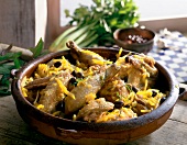Guinea fowl with pumpkin and black olive in serving dish