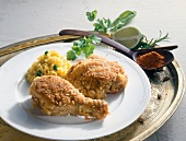 Close-up of chicken in almond crust with peas pilaf on plate