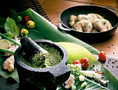 Marinade in mortar with banana leaves and vegetables