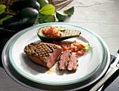 Grilled duck breast with avocado and tomato sauce on plate